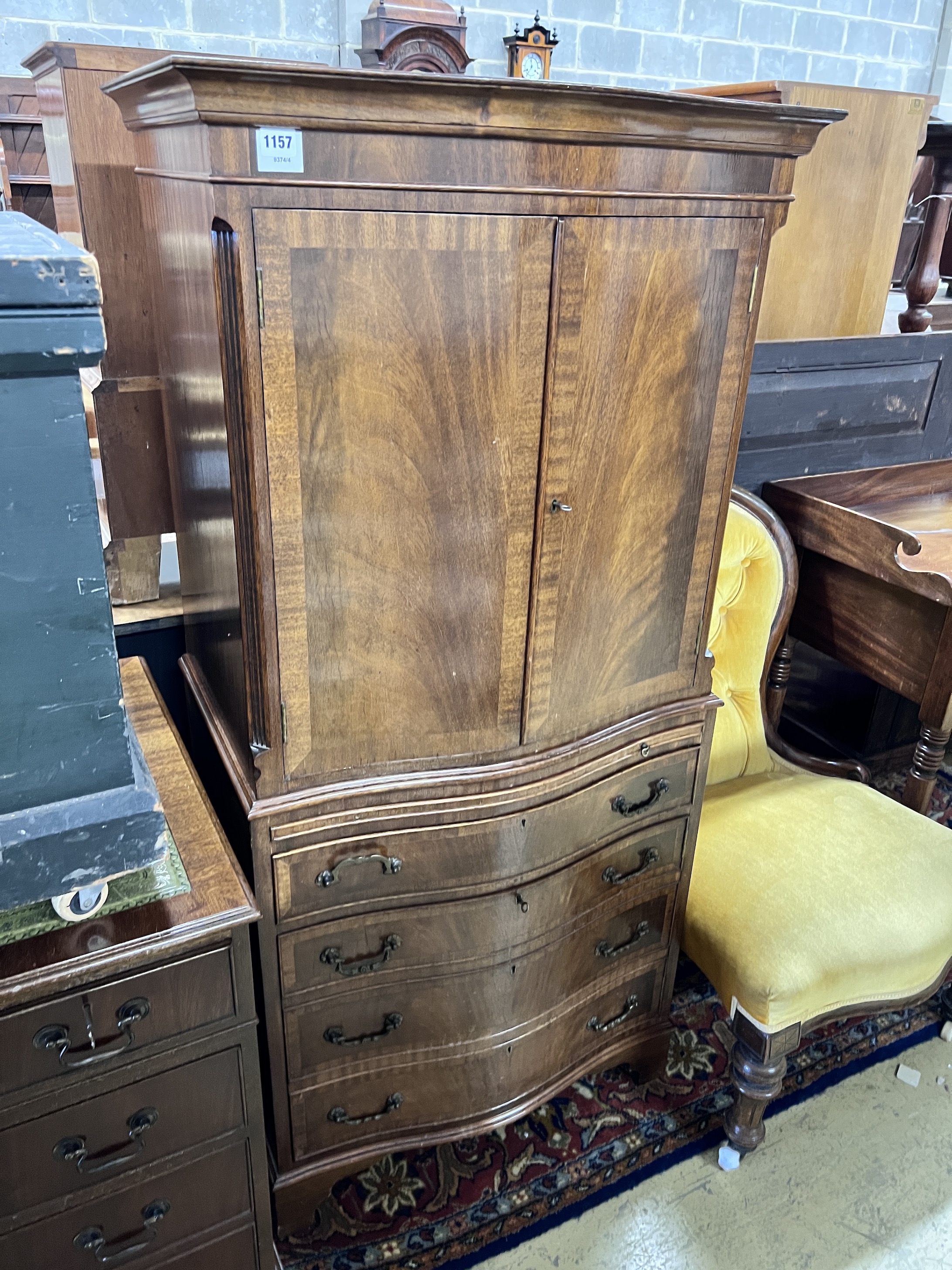 A mahogany serpentine cocktail cabinet fitted with four drawer base, width 73cm